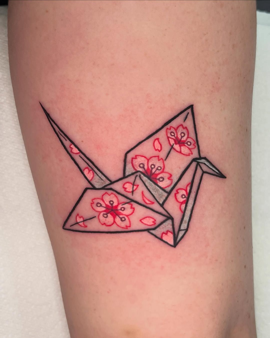Elegant origami crane with floral accents Tattoo Design
