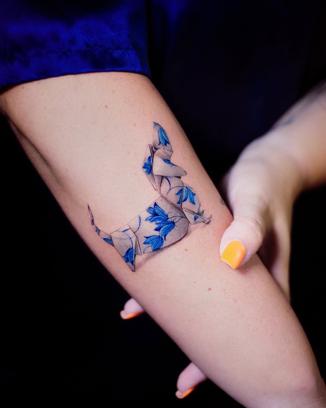 Elegant origami-inspired dog tattoo with flowers Tattoo Design