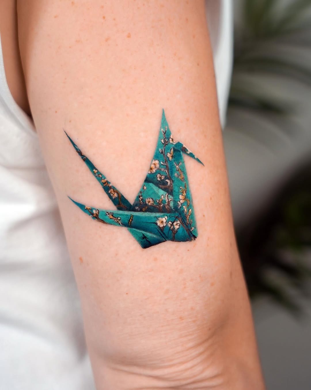 Intricate origami crane tattoo with floral detail Tattoo Design