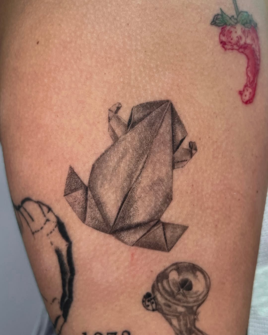 Stylish origami frog tattoo design on skin Tattoo Design