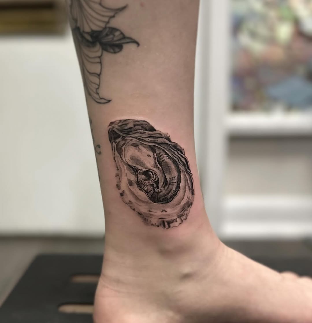 This gorgeous oyster tattoo showcases intricate detailing and stunning realism.