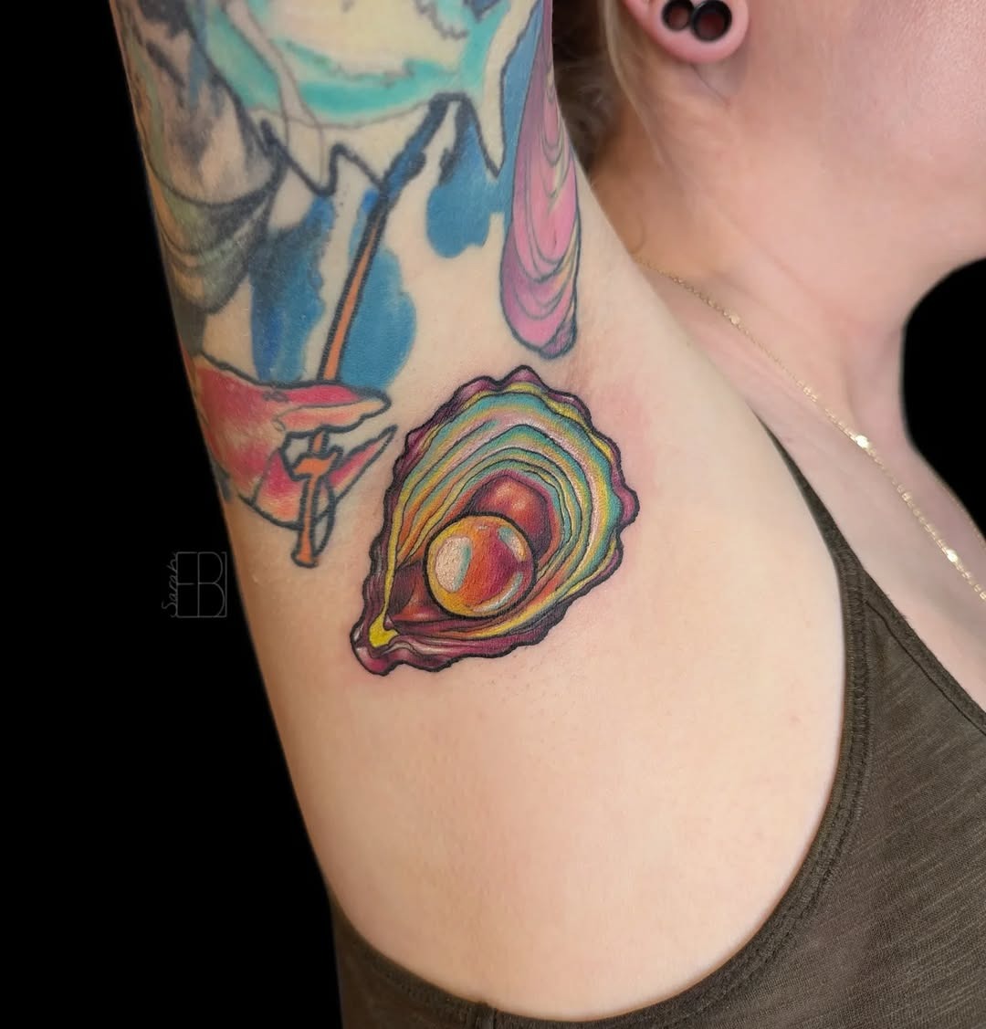 This stunning oyster tattoo showcases colors and intricate details.