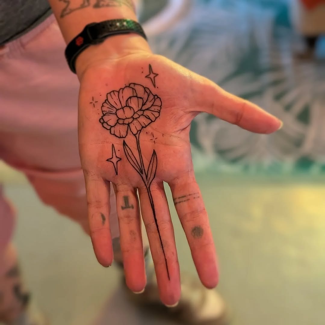 Elegant flower palm tattoo with star accents Tattoo Design