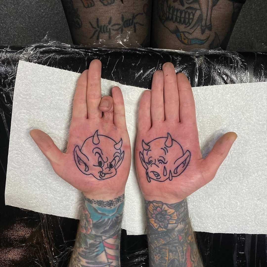 Playful devil designs on palm tattoos Tattoo Design