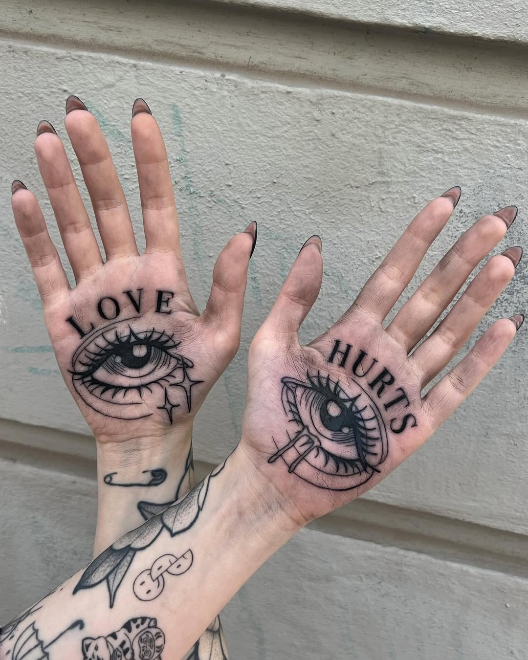 Unique palm tattoos expressing love and pain Tattoo Design