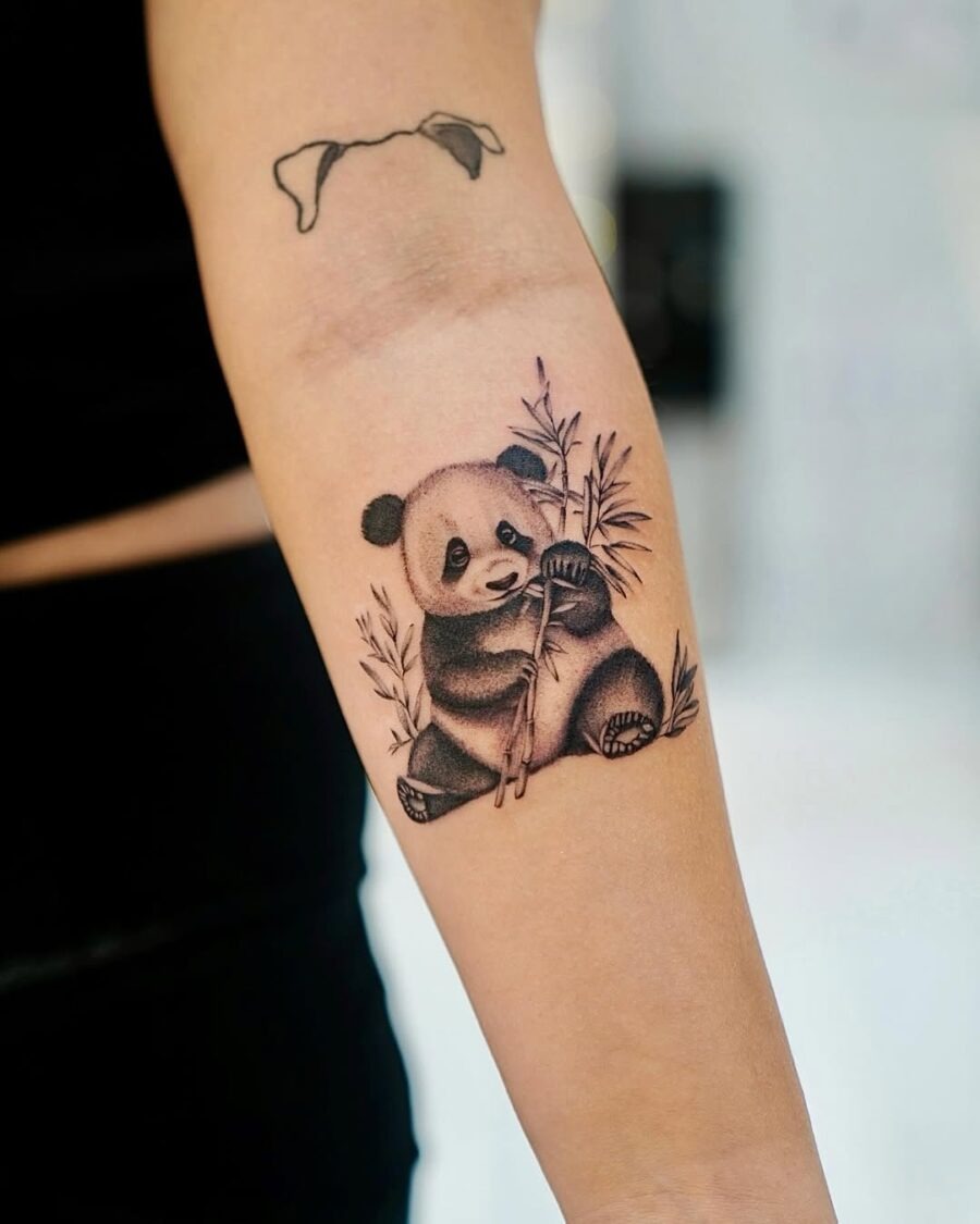 Adorable panda tattoo holding bamboo stalks Tattoo Design