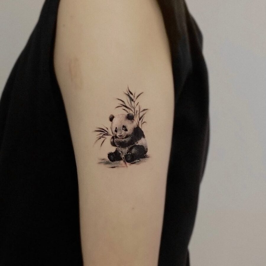 Adorable panda tattoo with bamboo accents Tattoo Design