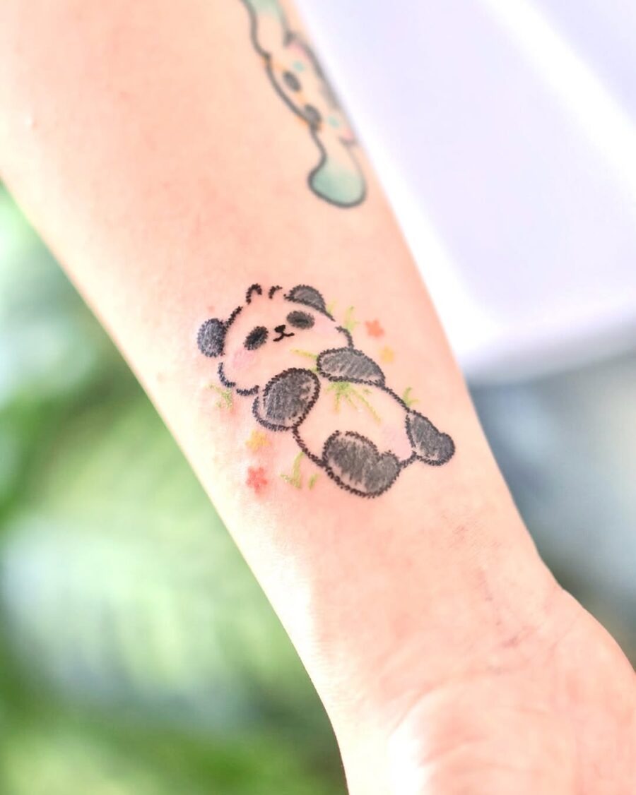 Adorable panda tattoo with floral accents Tattoo Design