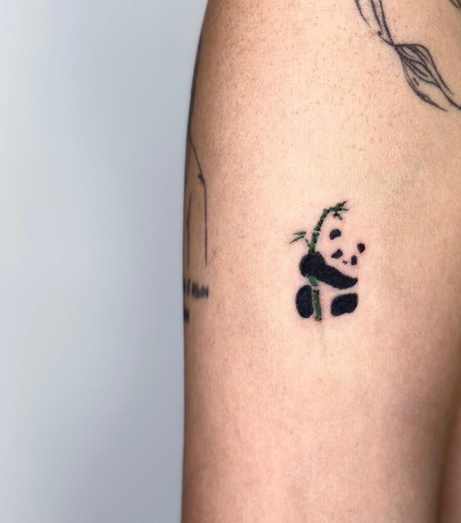 Adorable panda tattoo with playful bamboo details Tattoo Design