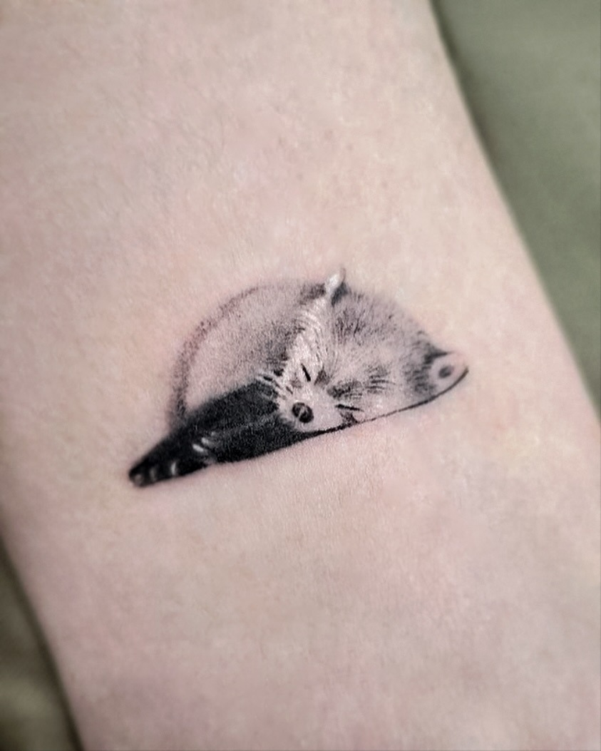 Elegant sleeping panda tattoo captures serene vibes Tattoo Design