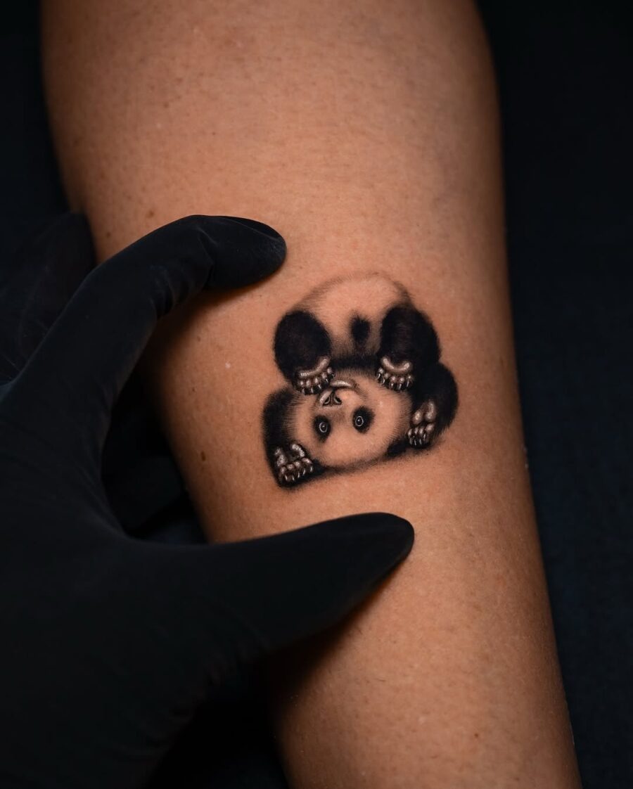 Realistic panda tattoo with playful pose Tattoo Design