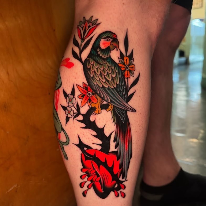 Bold parrot tattoo with vibrant floral accents Tattoo Design