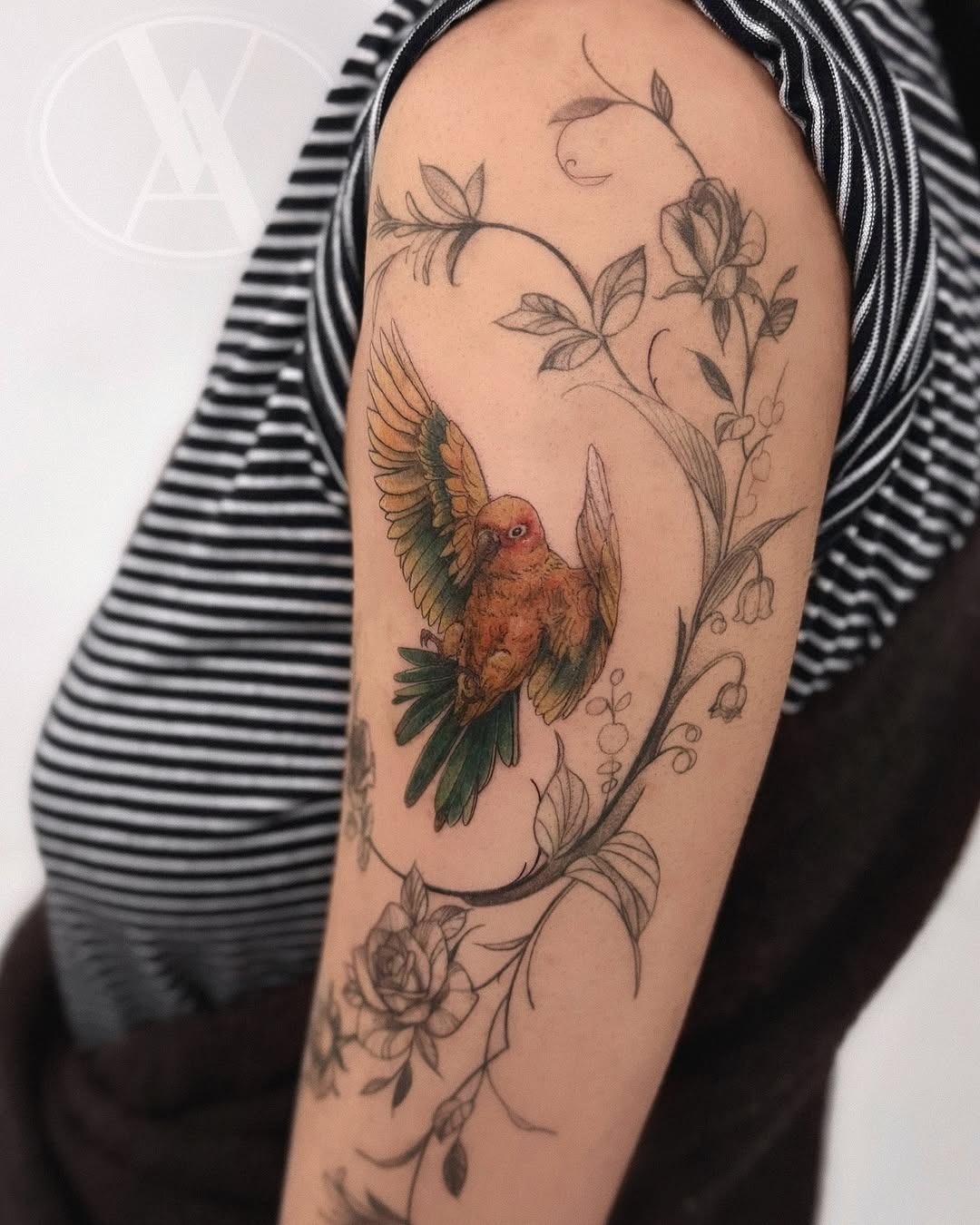Colorful parrot tattoo with floral embellishments Tattoo Design
