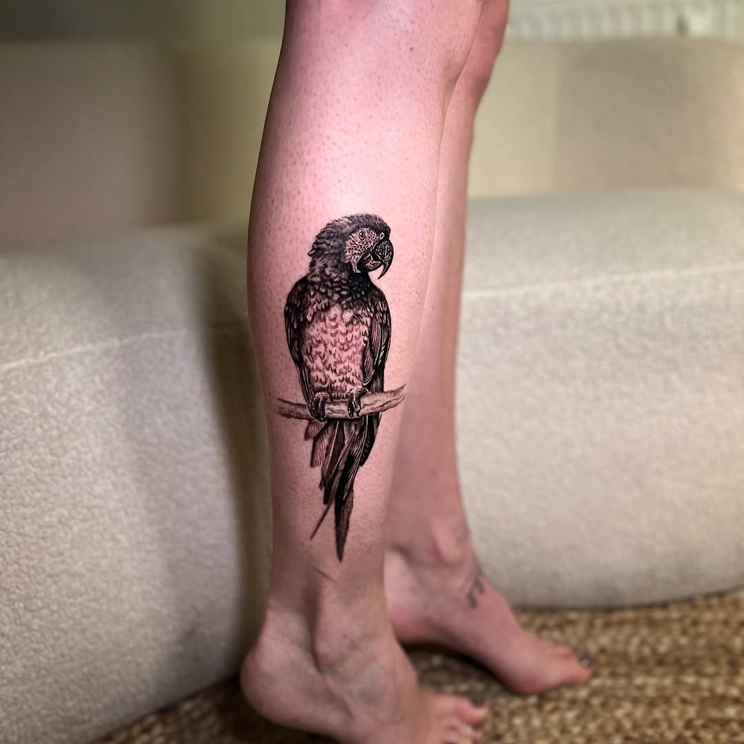 Expressive parrot tattoo design on leg Tattoo Design