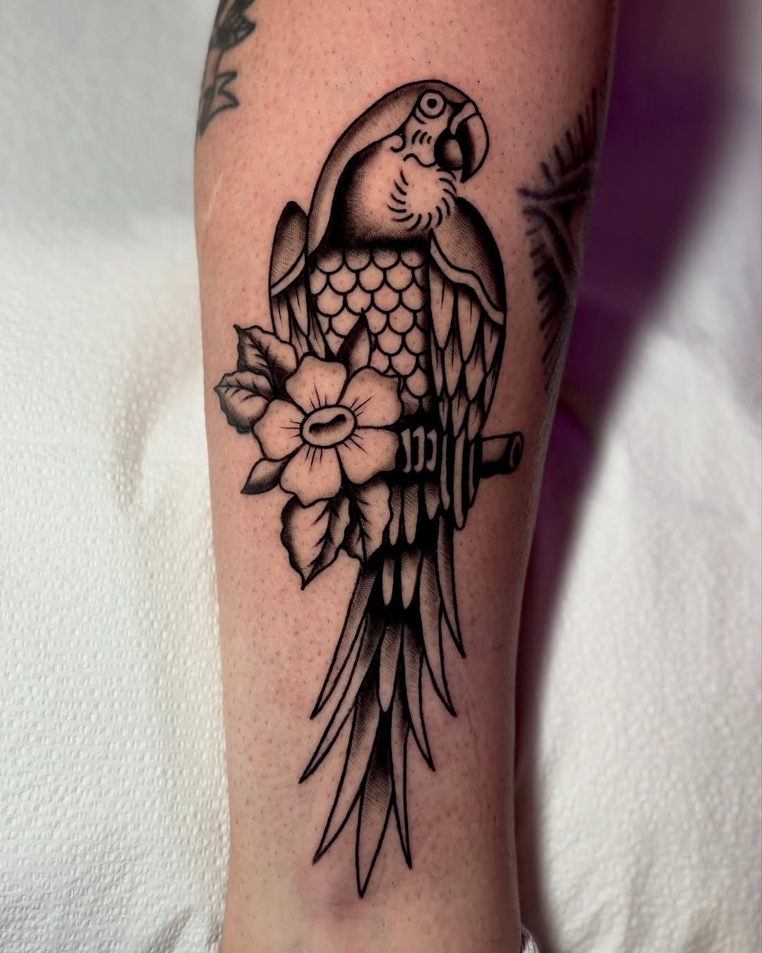 Stylish parrot tattoo with floral details Tattoo Design