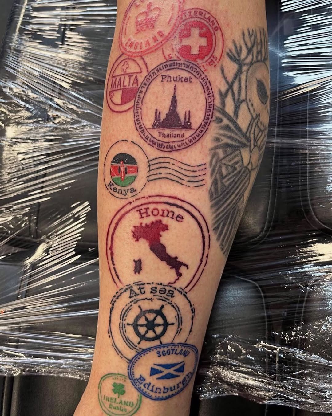 Unique passport stamps tattooed on forearm Tattoo Design