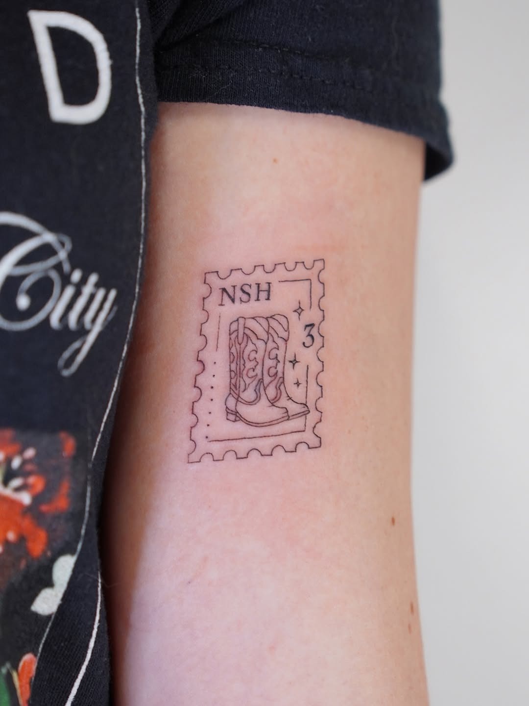 Unique stamp tattoo featuring cowboy boots Tattoo Design