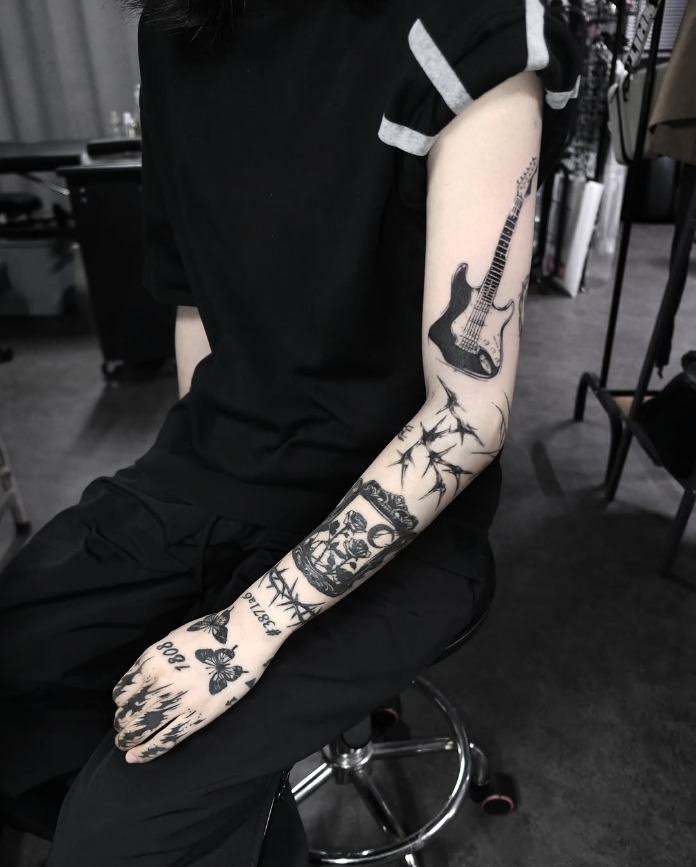 Gothic Rock-Inspired Patchwork Sleeve Tattoo Design
