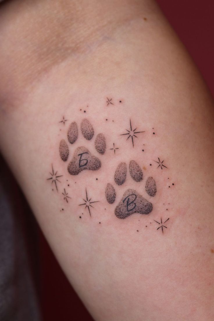 Initial Paw Prints with Stars Tattoo Design
