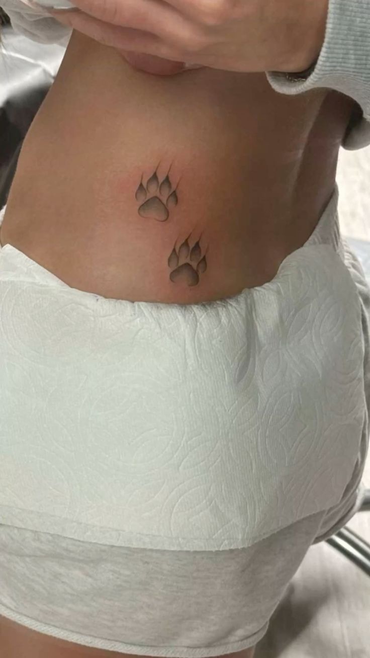 Minimal Clawed Paw Prints on the Hip Tattoo Design