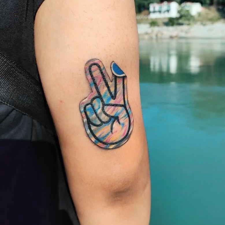 Colorful peace sign tattoo on arm close-up Tattoo Design