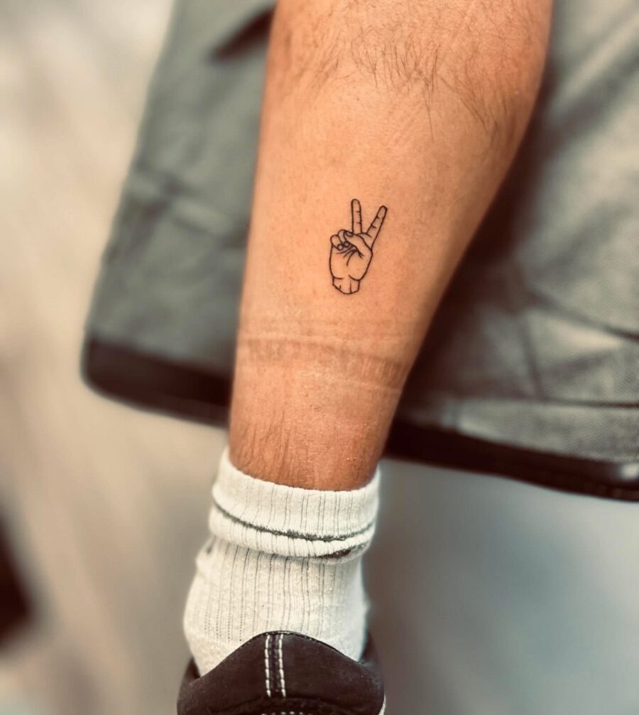 Minimalist peace sign tattoo on inner leg Tattoo Design