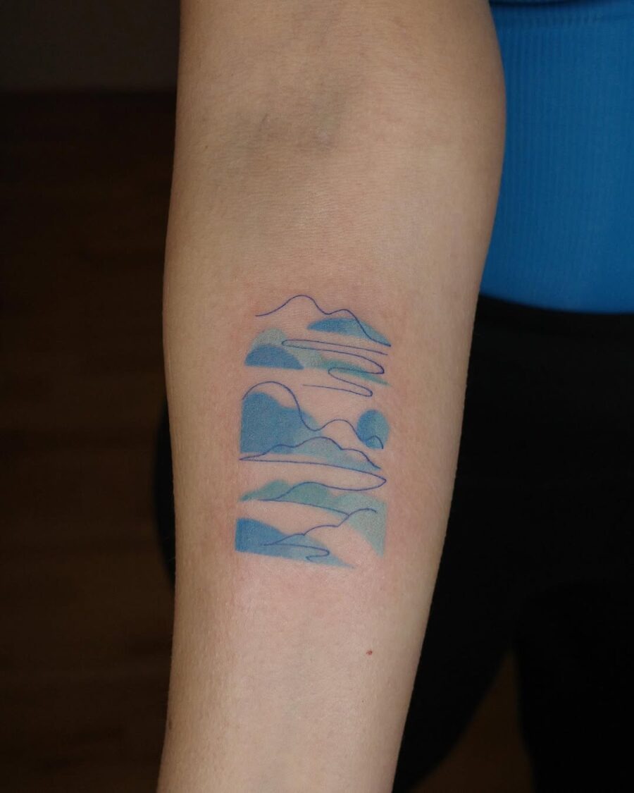 Serene mountains tattoo with calming blue hues Tattoo Design