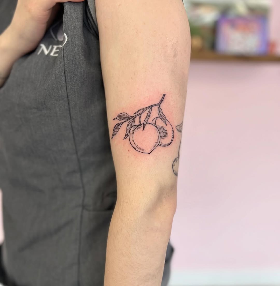 Charming minimalistic peach tattoo on arm Tattoo Design