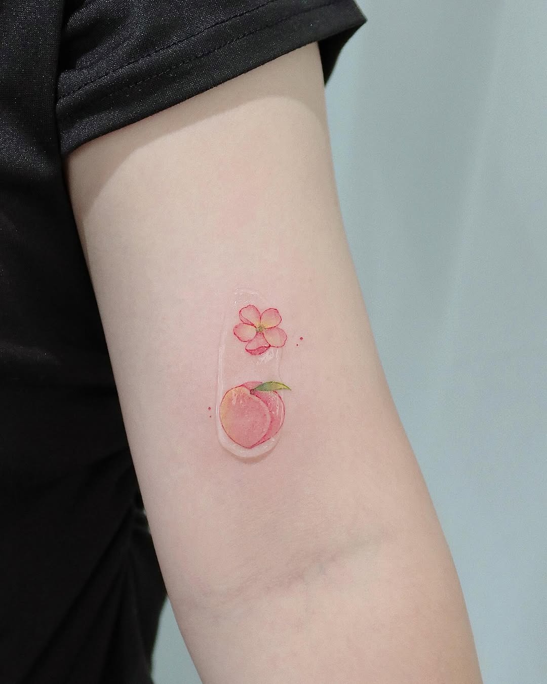 Charming peach and flower tattoo design Tattoo Design