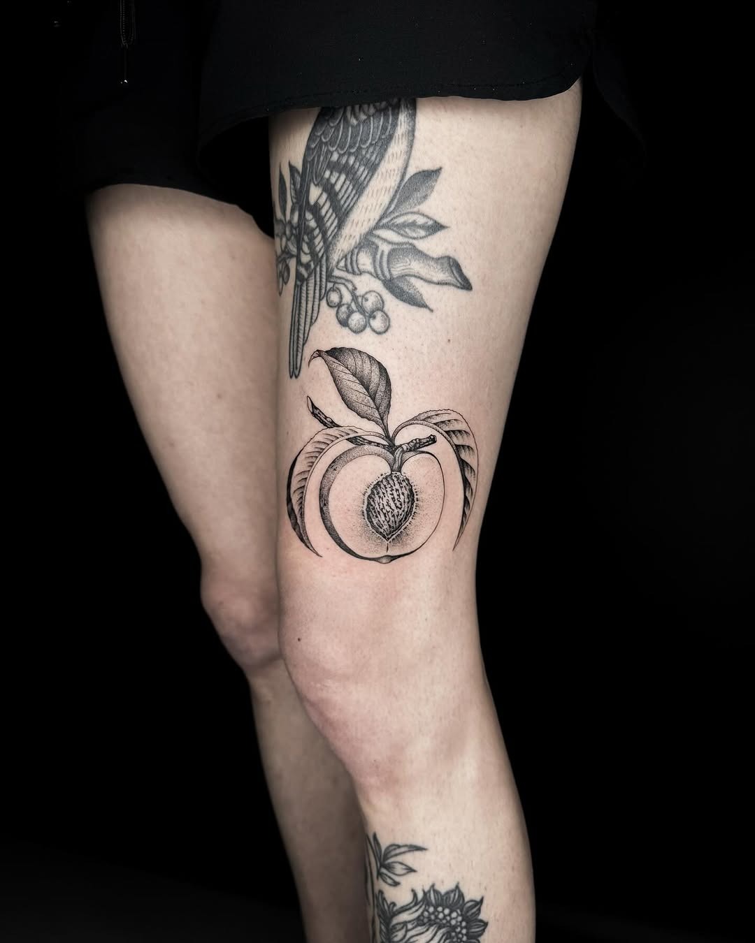 Elegant peach tattoo showcases bold blackwork artistry Tattoo Design