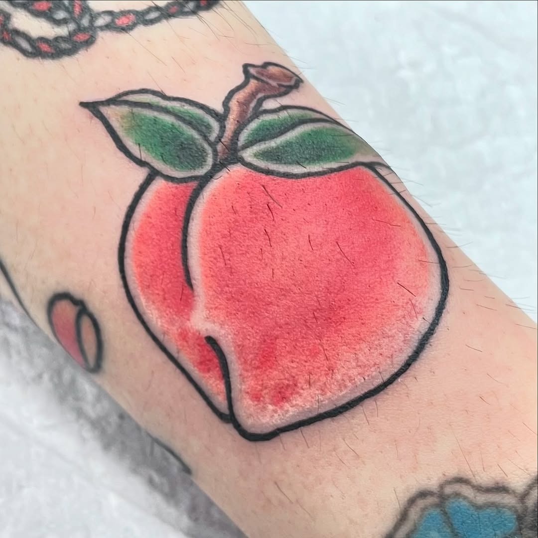 Vibrant peach tattoo capturing playful artistry Tattoo Design