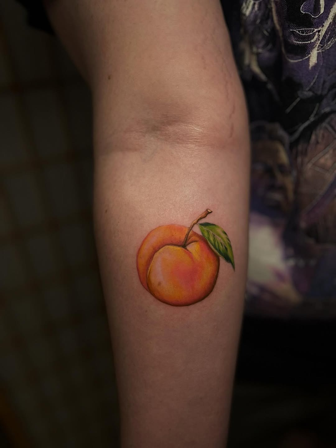 Vibrant peach tattoo on the inner arm Tattoo Design