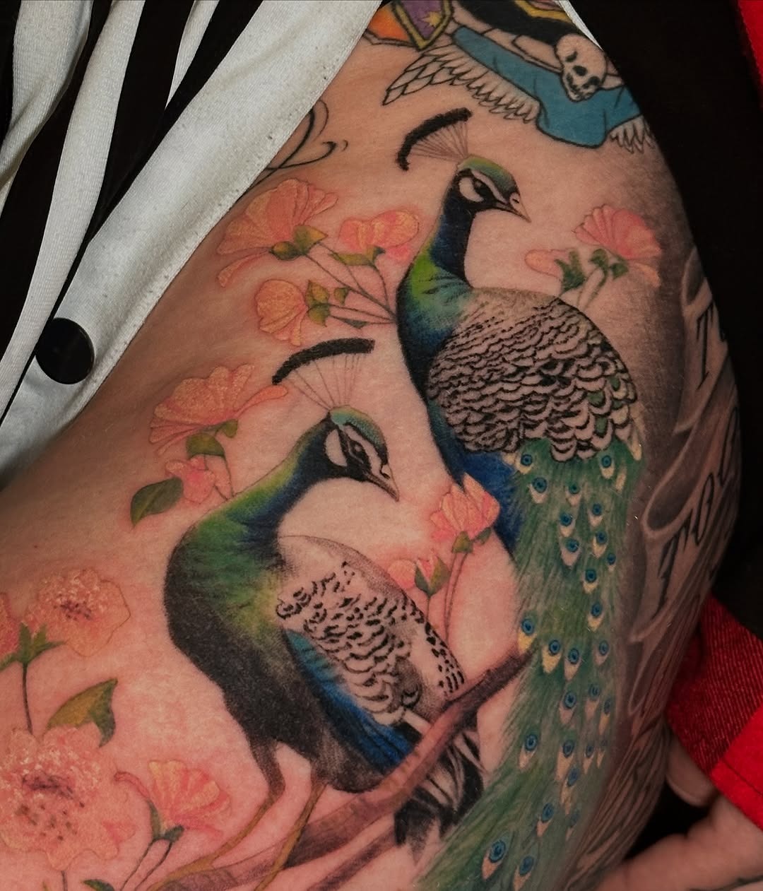 Elegant peacock tattoo with floral accents Tattoo Design