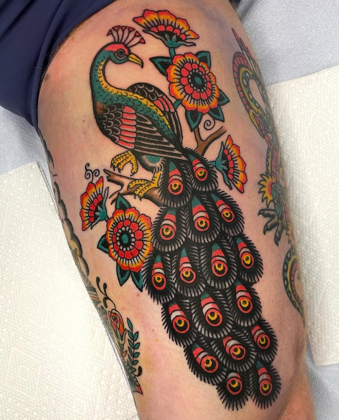 Stunning peacock tattoo with vibrant floral accents Tattoo Design