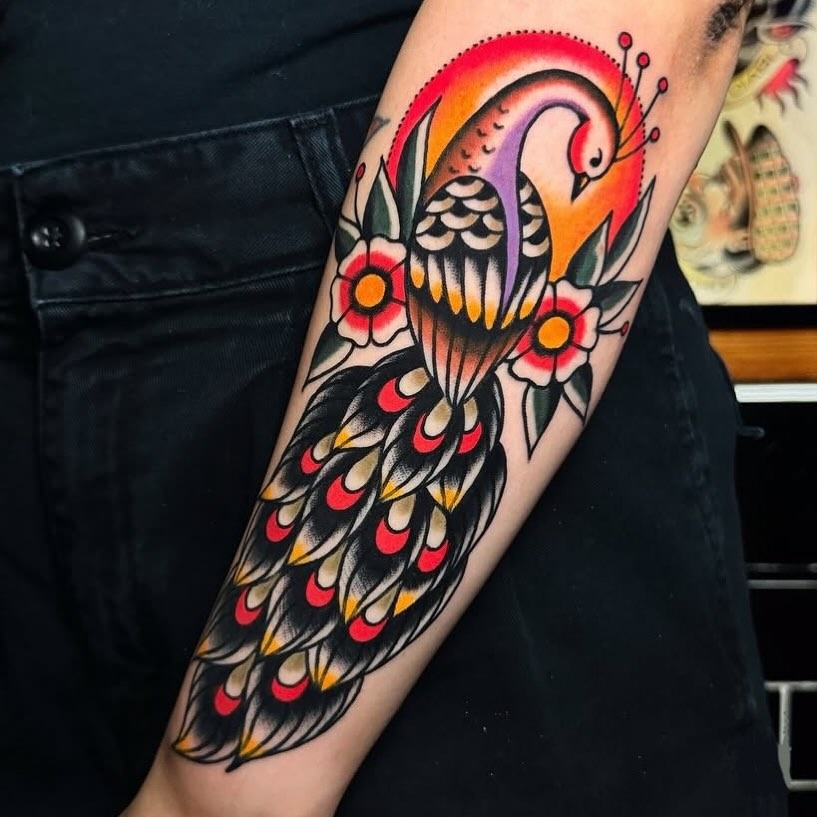 Vibrant peacock tattoo with floral accents Tattoo Design