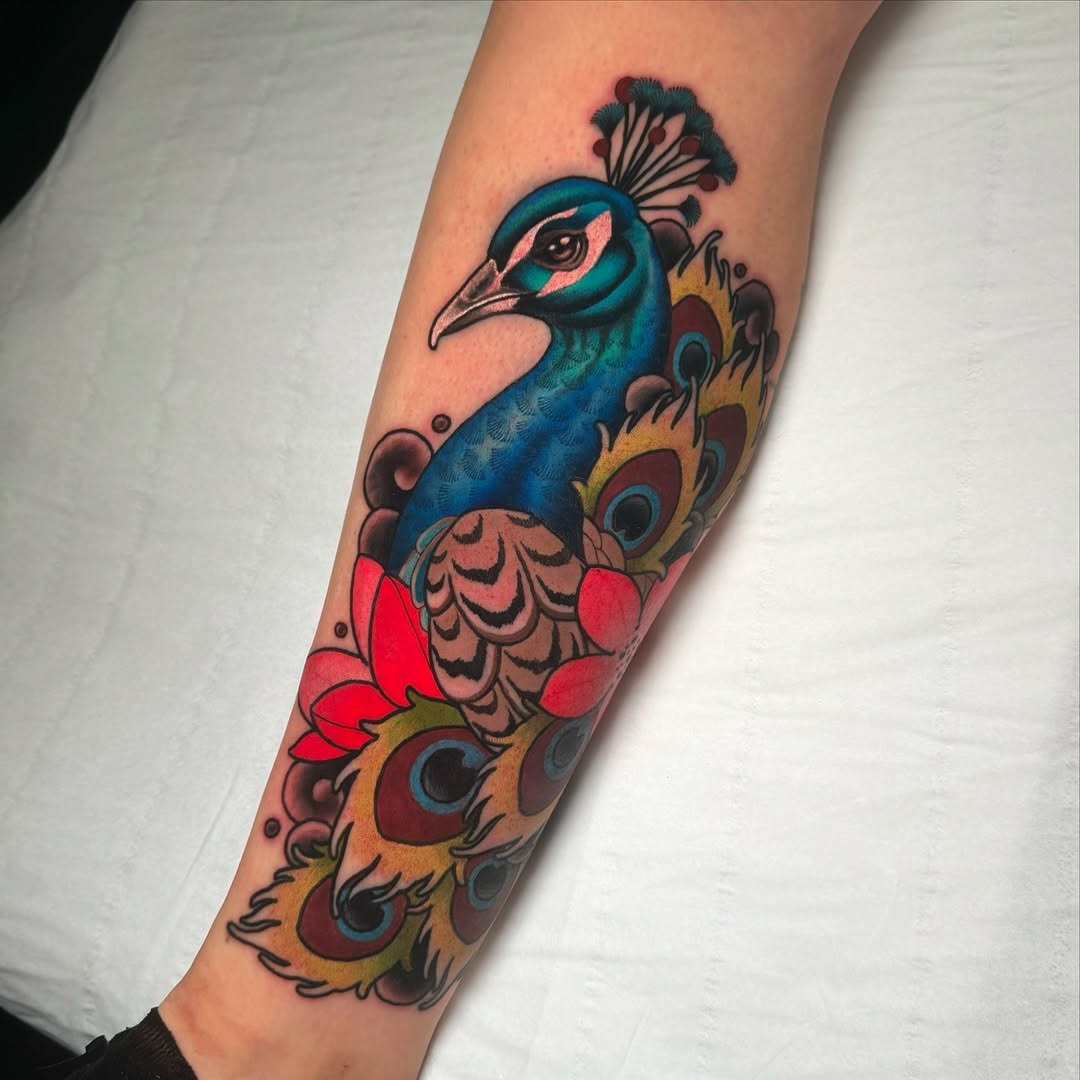Vibrant peacock tattoo with floral elements Tattoo Design