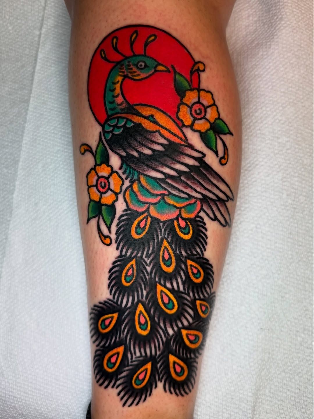 Vibrant Peacock Tattoo with Floral Elements Tattoo Design
