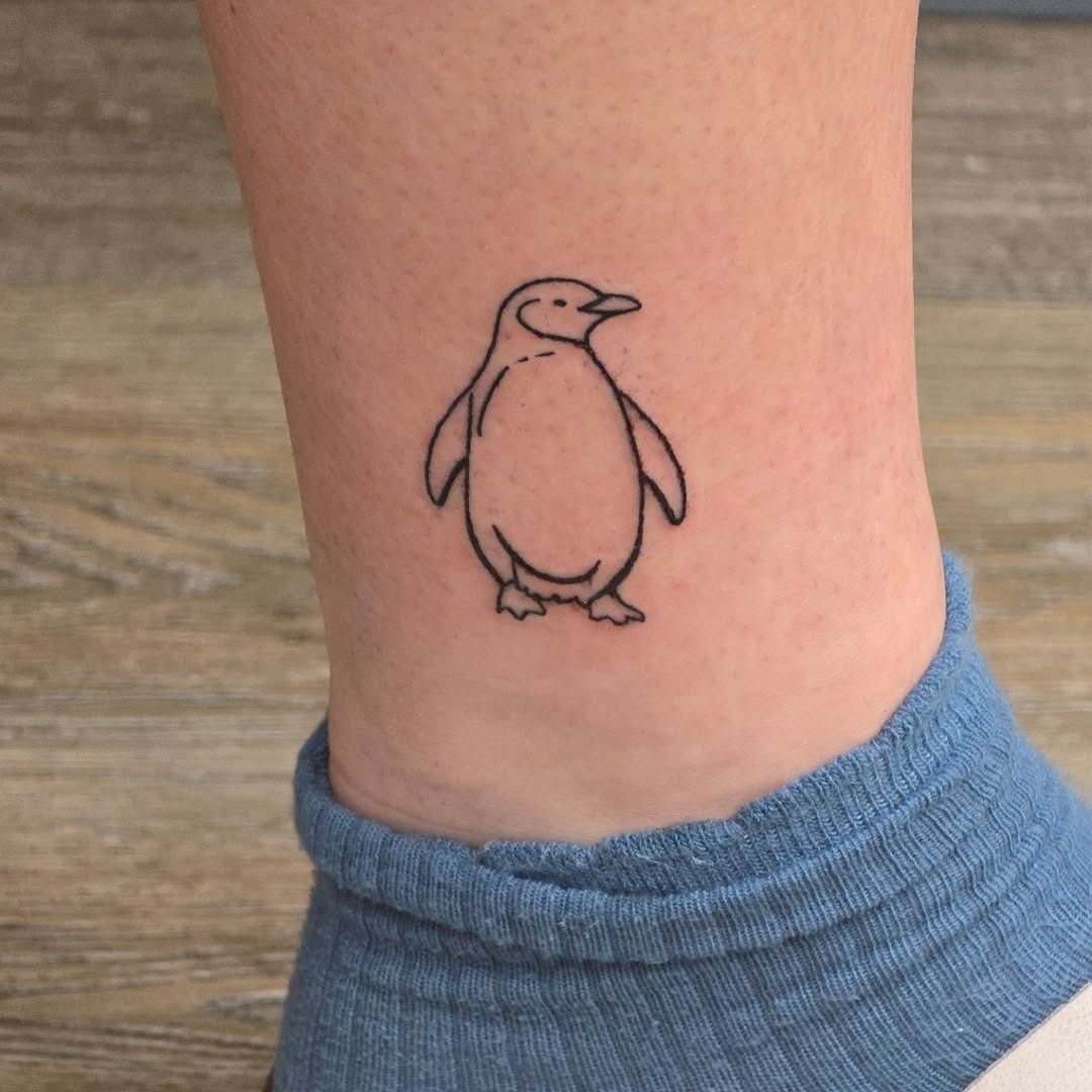 Charming minimalist penguin tattoo on the ankle Tattoo Design