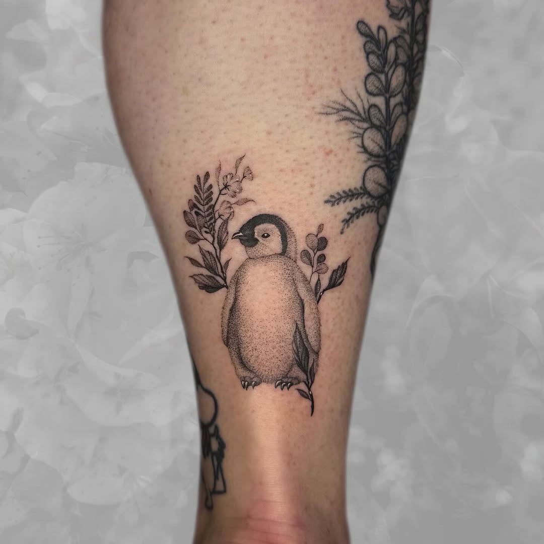 Charming penguin tattoo with floral accents Tattoo Design