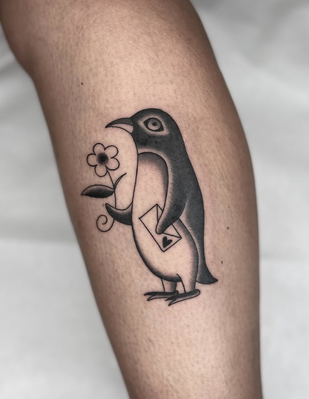 Charming penguin tattoo with flower and letter Tattoo Design