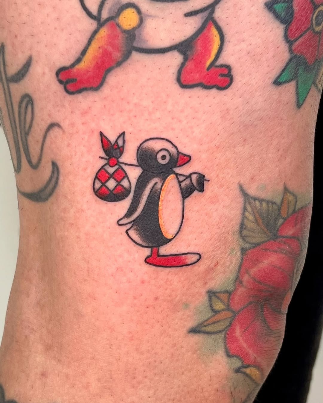 Charming penguin tattoo with playful vibes Tattoo Design