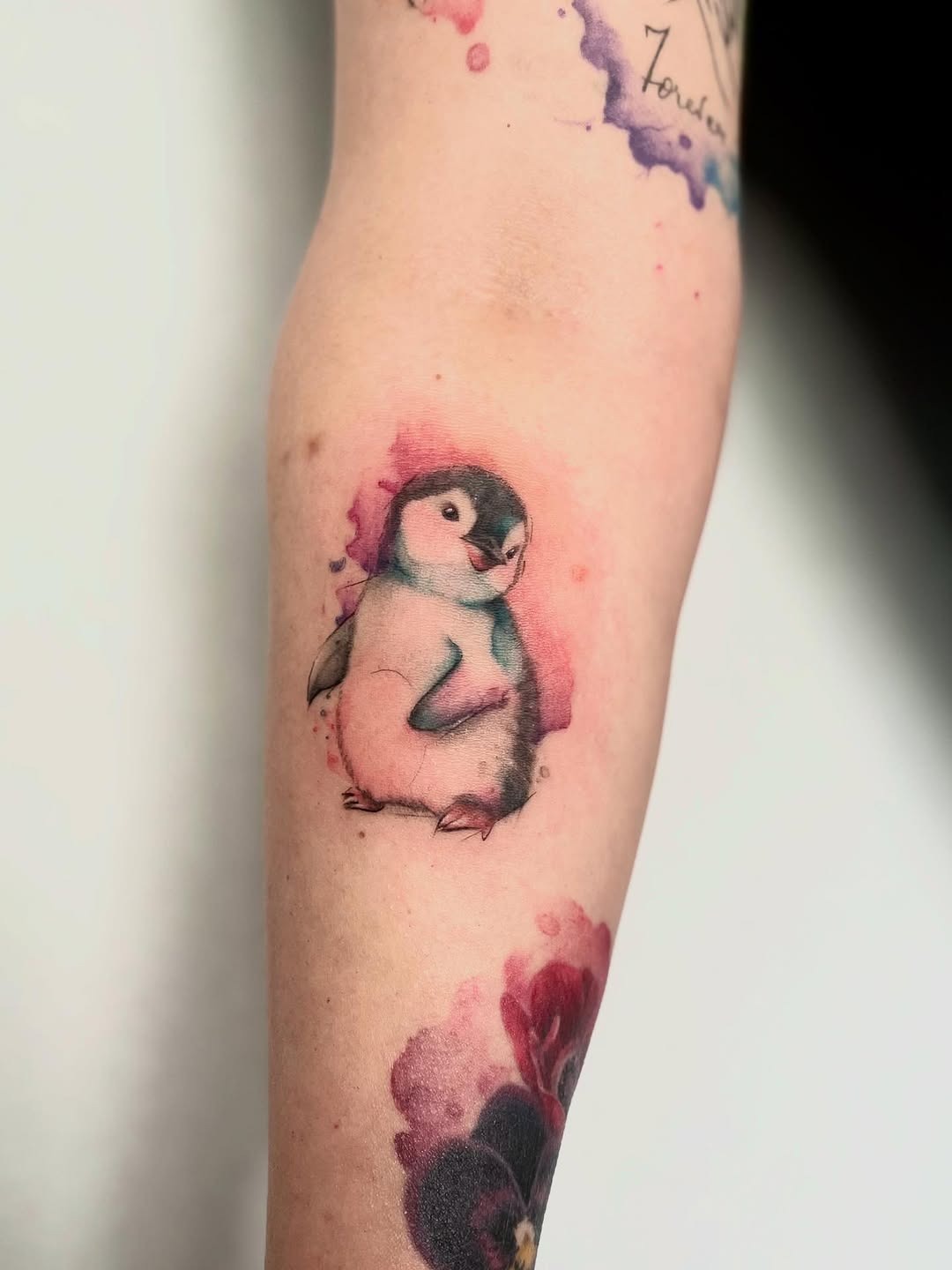Charming watercolor penguin tattoo on the arm Tattoo Design