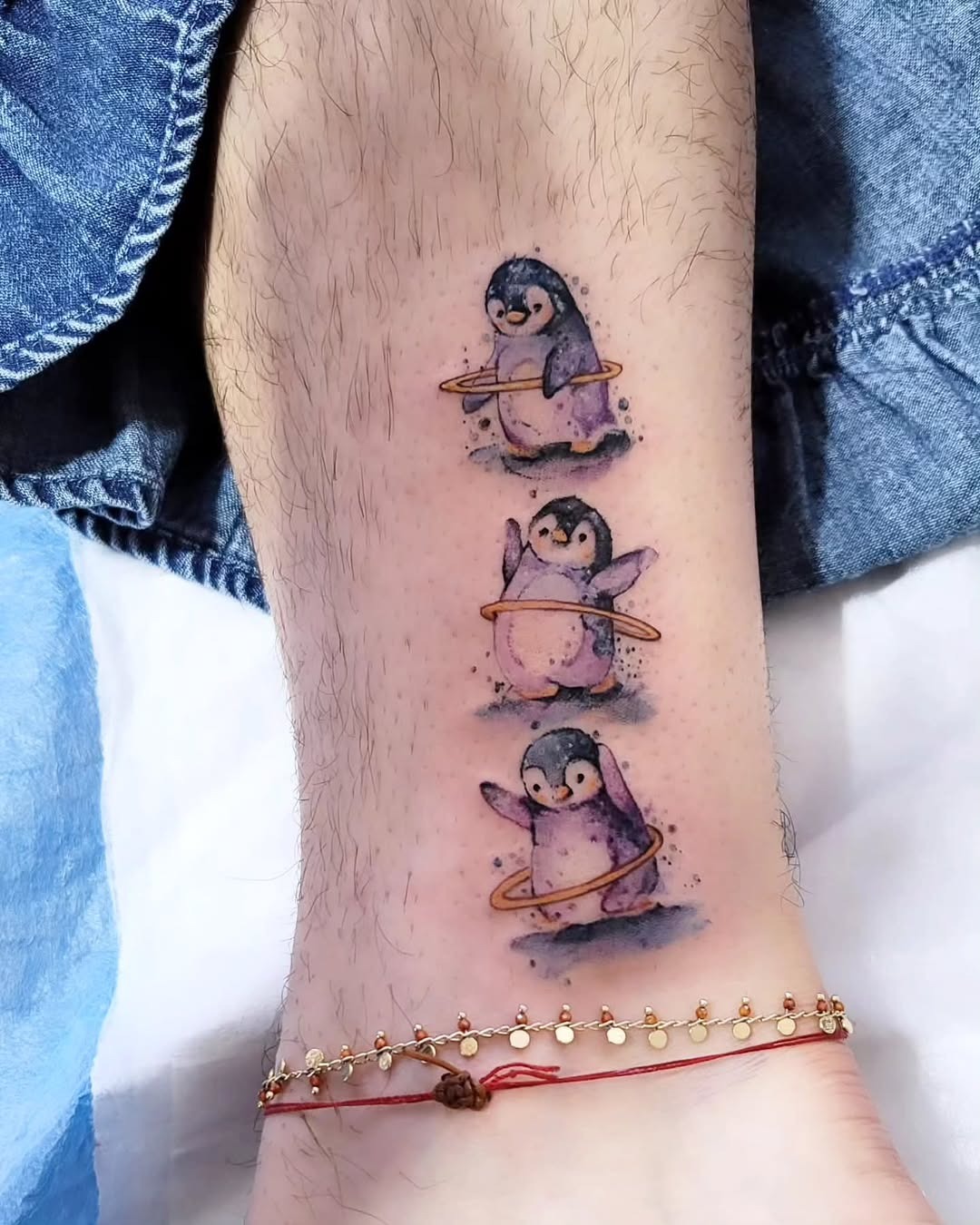 Delightful penguins enjoying a hula hoop dance Tattoo Design