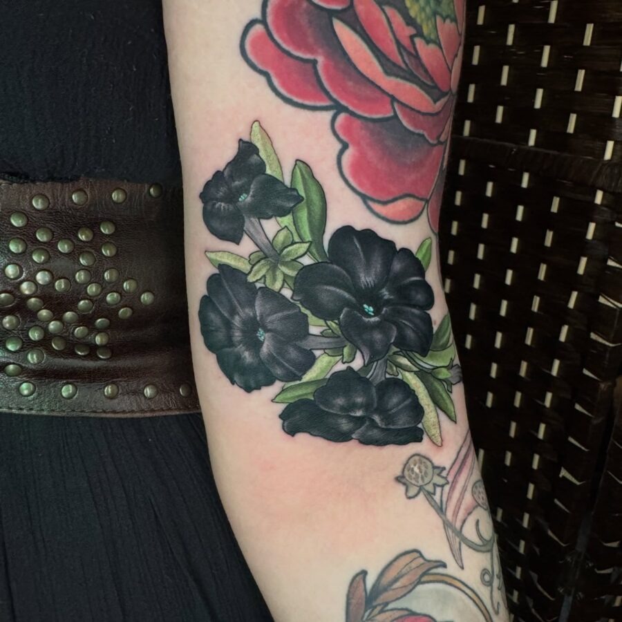 Stunning black petunia tattoo on the arm Tattoo Design
