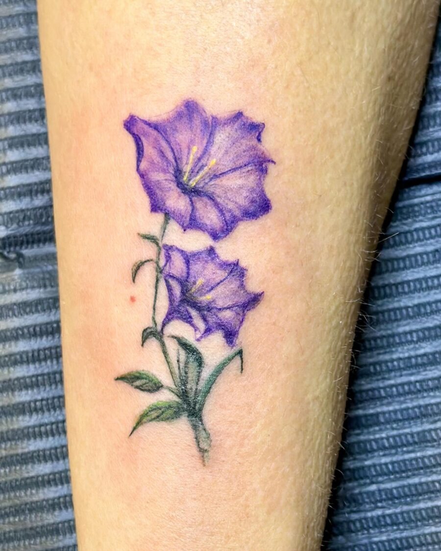 Stunning purple petunia tattoo on forearm Tattoo Design