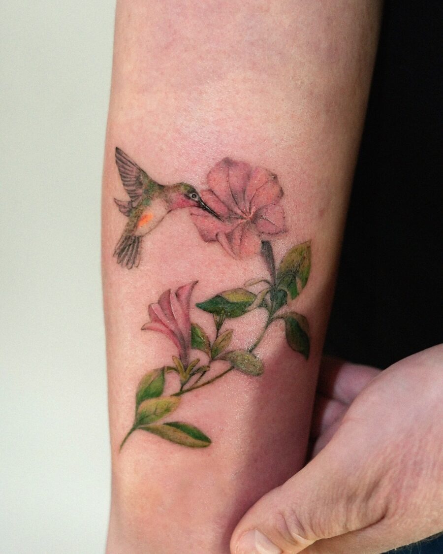 Vibrant petunia tattoo with hummingbird depiction Tattoo Design