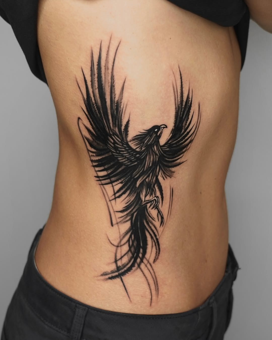 Dynamic phoenix tattoo design on side body Tattoo Design