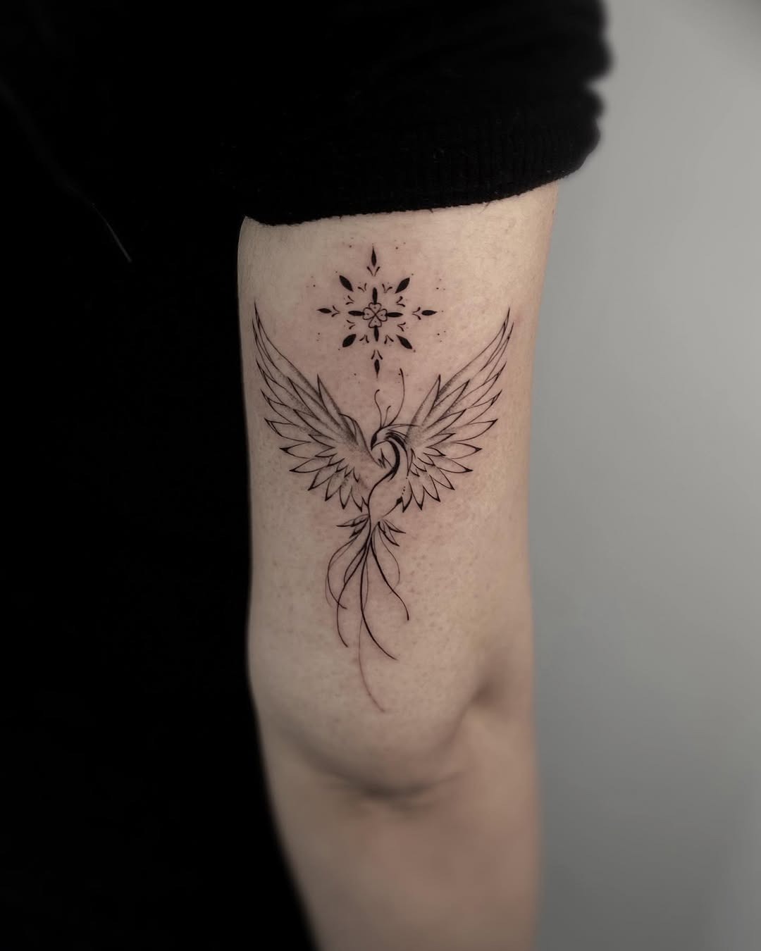 Elegant phoenix tattoo with graceful wings Tattoo Design