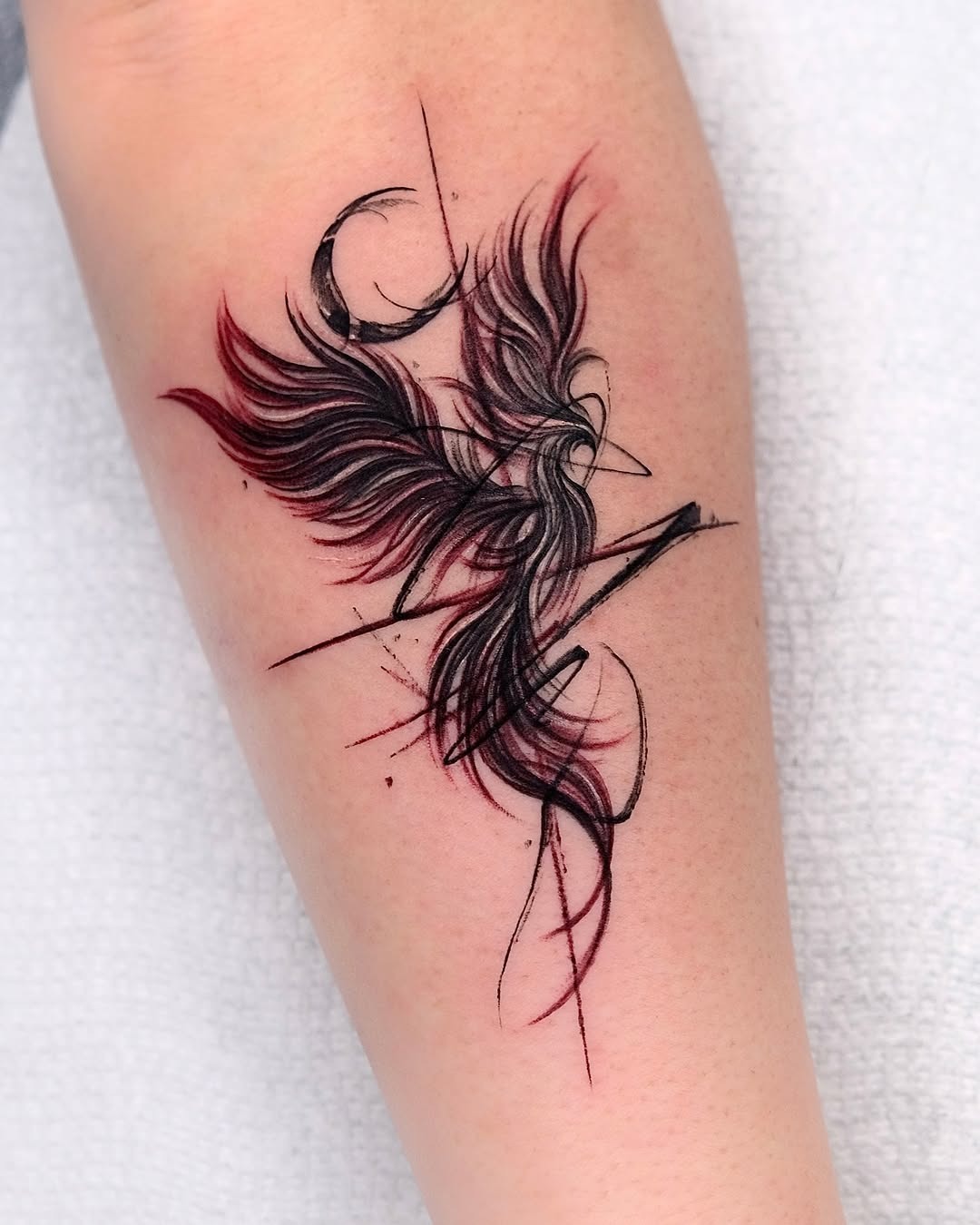 Elegant phoenix tattoo with striking red accents Tattoo Design
