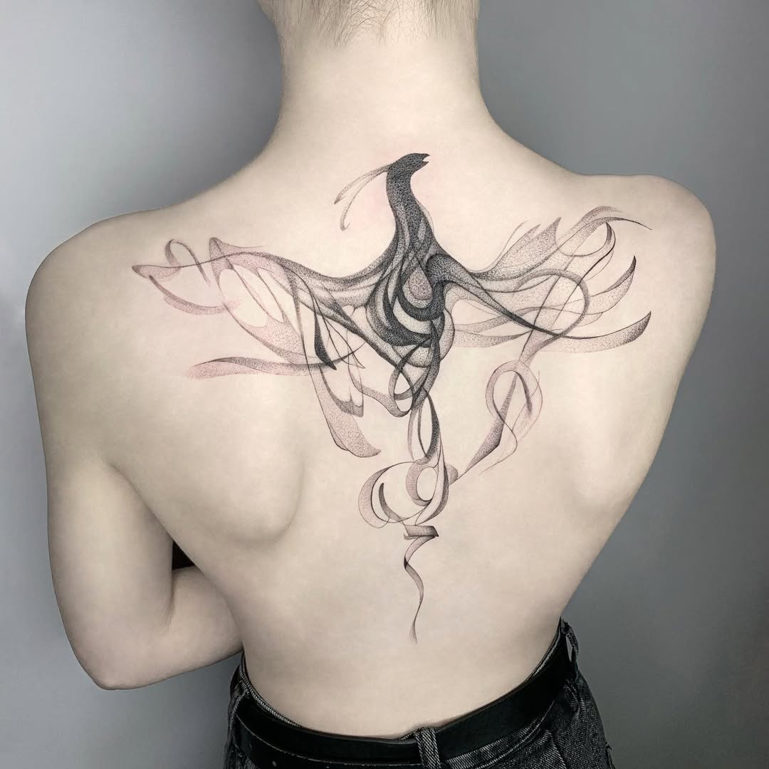 Elegant swirling phoenix tattoo on the back Tattoo Design